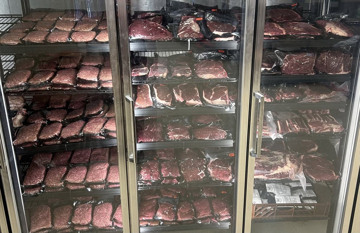 Glass-door cooler full of vacuum-sealed ground beef, steaks and roasts